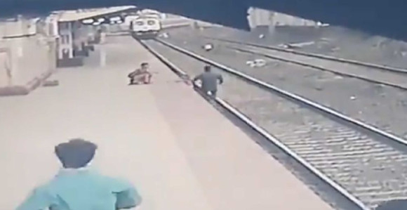 Indijski železničar spasao dete sa šina tik ispred voza! (VIDEO)