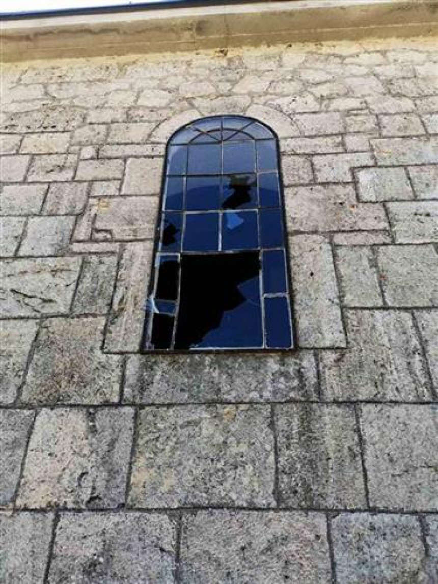Polupani prozori na crkvi i nagrobni spomenik